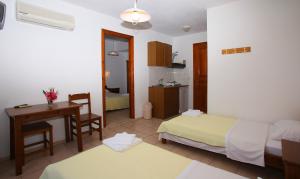 1 dormitorio con cama, escritorio y mesa en Nepheles, en Skopelos Town