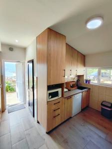 a kitchen with wooden cabinets and a microwave at Vukićević House in Kotor +8 photos