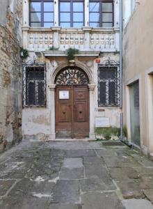 a building with a large wooden door in a street at Apartment Sonce in Koper