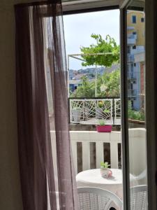 a view of a balcony with a table and a window at Apartmani SAMB Igalo in Herceg-Novi