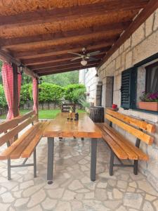 two wooden benches sitting on a patio at Antini dvori in Imotski