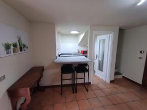 a kitchen with two bar stools and a counter top at Casa Clotilde in Verbania