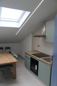 a kitchen with a table and a skylight at Dimora Saracena in Termoli