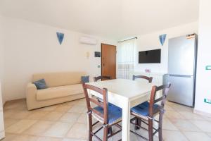 a living room with a table and chairs and a couch at Charming Room with two beds -2 minutes to the beach- in Olbia