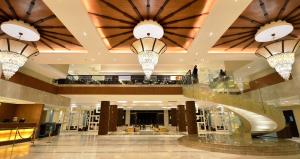 a lobby with three chandeliers in a building at Henann Resort Alona Beach in Panglao +181 photos
