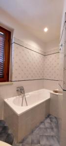 a white bath tub in a bathroom with a window at Villa Libertà in Siracusa +33 photos