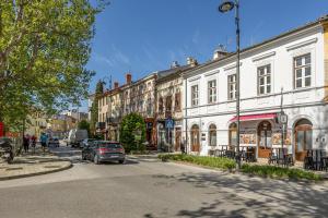 a street with buildings and a car on the road at Apartmani Leo centar in Crikvenica