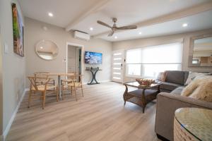 a living room with a couch and a table at La Jolla Windansea Luxury Apt in San Diego