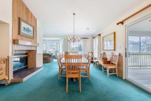 a dining room with a table and chairs and a fireplace at The Shabedge at Ships Watch in Duck