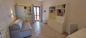 a living room with a couch and book shelves at Villa Libertà in Siracusa