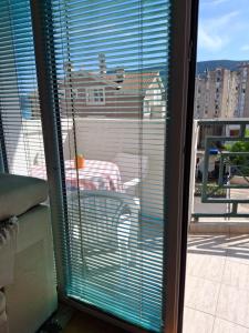 a view of a window with blinds on a balcony at Apartmani SAMB Igalo in Herceg-Novi