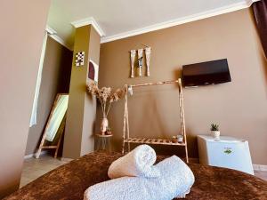 a bedroom with a bed with a tv on the wall at WoodSea in Batumi +61 photos