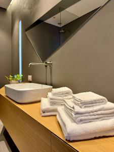 a bathroom with a sink and towels on a counter at Residenza d'Artista al Conservatorio in Salerno +53 photos