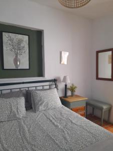 um quarto com uma cama e uma fotografia na parede em Quinta da Maínha - Charming Houses em Braga
