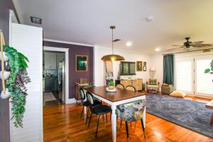 a kitchen and living room with a table and chairs at The Moody Manor -Luxurious Home Recently Renovated Close to Beach and Downtown in St. Augustine