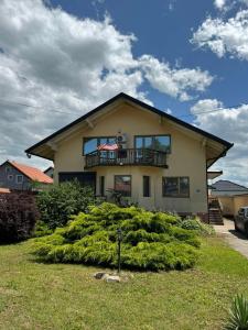 a house with a balcony on top of a bush at Vila Andrijana in Bijeljina