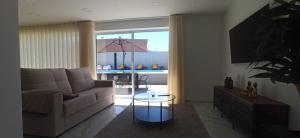 a living room with a couch and a table at Solar da Pedra in Paços de Ferreira