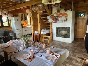 a room with a table with balloons and a fireplace at Ranczo Targoszów in Targoszów