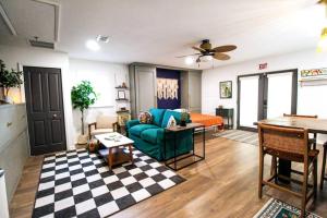 a living room with a couch and a table at The Mini Moody - Luxurious Home Recently Renovated Close to Beach & Downtown in St. Augustine
