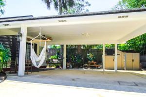 a screened porch with a hammock on a house at The Mini Moody - Luxurious Home Recently Renovated Close to Beach & Downtown in St. Augustine