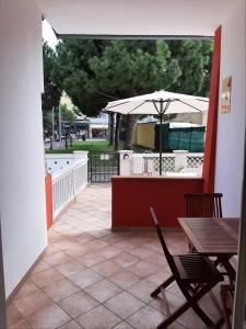 an outdoor patio with a table and an umbrella at La Casa dei Pescatori in Caorle