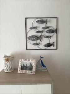 a picture on a wall above a shelf with a picture at La Casa dei Pescatori in Caorle +24 photos