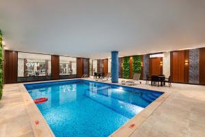 a large swimming pool in the middle of a house at Yas Hotel Apartments in Riyadh