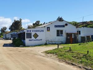 a building on the side of a dirt road at Kingfisher by the river - self catering in Velddrif +8 photos