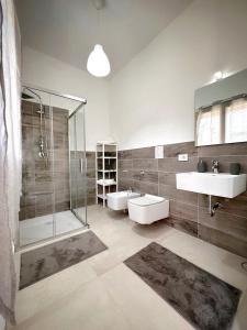 a large bathroom with two sinks and a shower at Villa Isma Superior Rooms in Realmonte