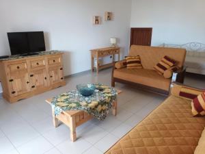 - un salon avec un canapé et une télévision dans l'établissement Vacanze Sicilia, à Trappeto