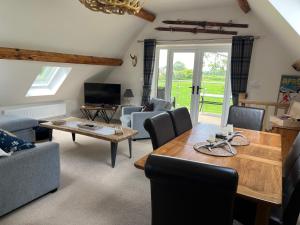 a living room with a wooden table and chairs at Picket Post House Bed & Breakfast in Catterall