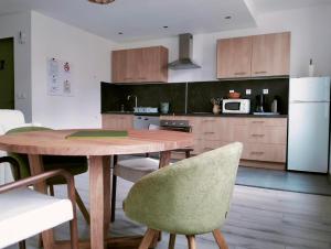 a kitchen with a wooden table and some chairs at La Provence vous Attend - 2ème étage in Digne-les-Bains