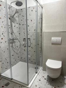 a bathroom with a shower with a toilet at APARTMANI 4 PALME in Starigrad-Paklenica