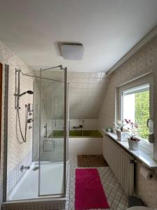 a bathroom with a shower and a bath tub at kukione Ferienwohnung in Dettingen an der Erms +63 photos
