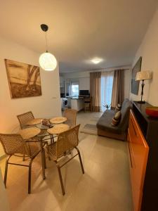 a living room with a table and chairs and a couch at Rincón de María - Ganador Traveller Awards 2025 y 2026 in Playa de Gandia