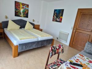 1 dormitorio pequeño con 1 cama y 1 sofá en Hotel Garni Hutter en Unterburg am Klopeiner See