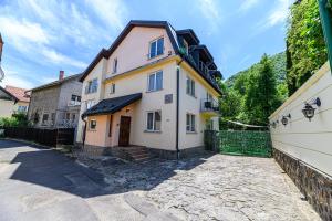 a large house with a fence in front of it at Pensiunea Casa Bono - Cazare Brasov in Braşov