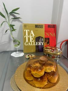 a plate of donuts on a table with a book at NarPera Taksim Boutique Hotel in Istanbul