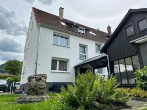 a white house with a black roof at kukione Ferienwohnung in Dettingen an der Erms