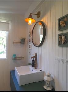 ein Badezimmer mit einem weißen Waschbecken und einem Spiegel in der Unterkunft Quinta da Maínha - Charming Houses in Braga