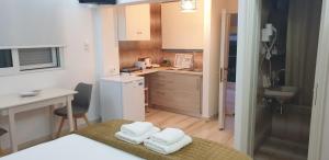 a small kitchen with white towels on a table at Vaso Studios in Vathi