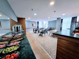 a buffet in a hotel room with food on a counter at Uyu Room Adana Hotel in Seyhan