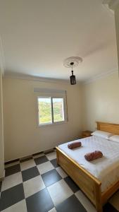 Voodi või voodid majutusasutuse Appartement 4 en bord de la mer à Azla toas