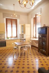 a kitchen with a table and chairs in it at Dimora Altemura in Lucca