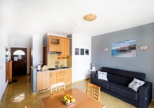 a living room with a couch and a table at Apartment Zen u Postira in Postira