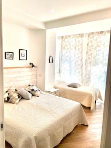 Voodi või voodid majutusasutuse Catalogna10 Rooms toas