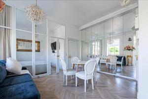a living room with a table and chairs and a dining room at Apartament Meduza Nadmorskie Miejsce in Gdynia