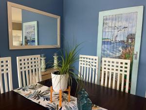a dining room with a table with a potted plant on it at Su Casa Port Alfred in Port Alfred