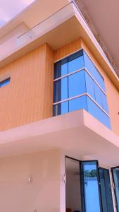 a facade of a house with glass windows at Villa Victoria Résidence in Lomé