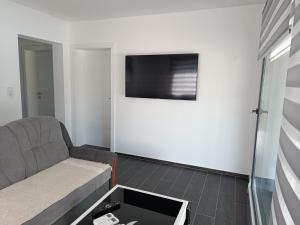 a living room with a couch and a flat screen tv at Eurouna relax in Bosanska Krupa